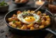 Pyttipanna con alcaparras y huevo estrellado servido en plato oscuro